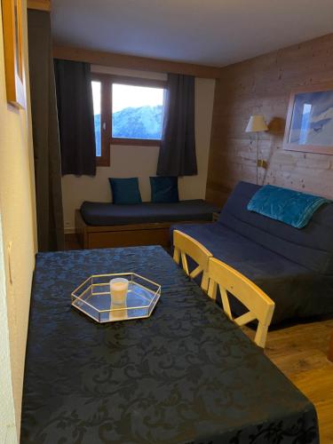 a room with a bed and a table with a tray on it at Studio centre station avec balcon in LʼHuez