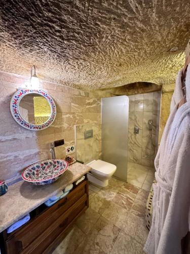 a bathroom with a sink and a toilet at Canela Cave Hotel - Cappadocia in Goreme