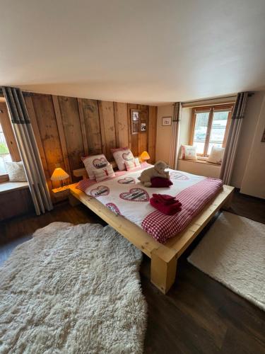 a bedroom with a bed with a teddy bear on it at L'Atelier D' en Bas in La Tine