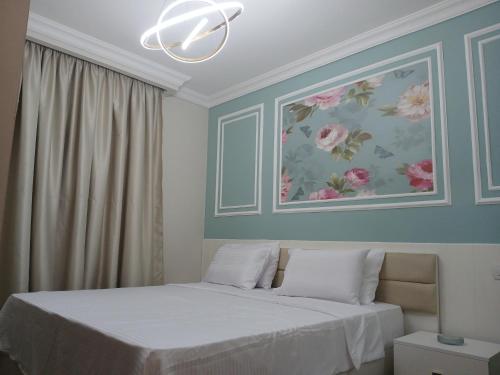 a bedroom with two beds and a painting on the wall at Dar Residence - Madinaty B12 - U2 - 2 BR - New Cairo in Madinaty