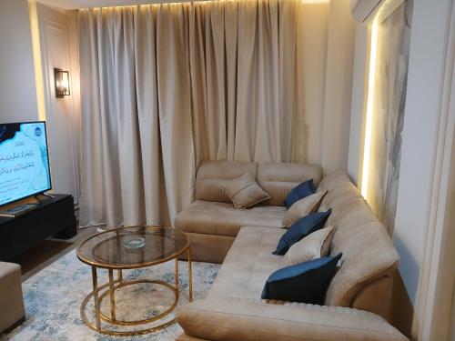 a living room with a couch and a table at Dar Residence - Madinaty B12 - U2 - 2 BR - New Cairo in Madinaty
