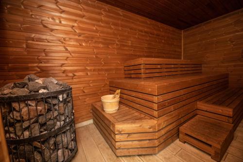 a wooden sauna with a trash can next to it at Chalupa Dešná in Dešná