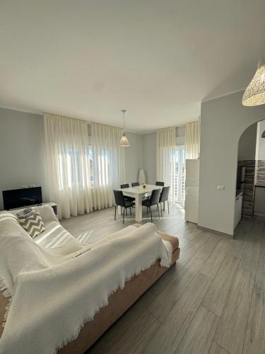 a bedroom with a large bed and a table with chairs at La Casa Vista Mare in Fregene
