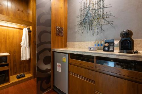 a kitchen with a counter with a coffee maker at Sawasdee Village in Kata Beach