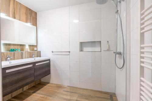 a bathroom with a shower and a sink at Appartementencomplex Juliana 166 in De Koog