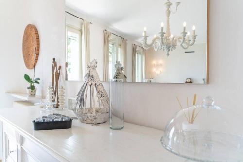 a white room with a counter with a mirror at Villa Rosa del Garda Golf and Bike in Garda