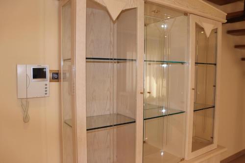 a wooden cabinet with glass doors in a room at Casa Pueblo Medieval de Pals in Pals