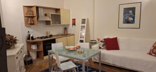 a small living room with a table and a couch at Exclusive Aparthotel La Reunion in Ravenna