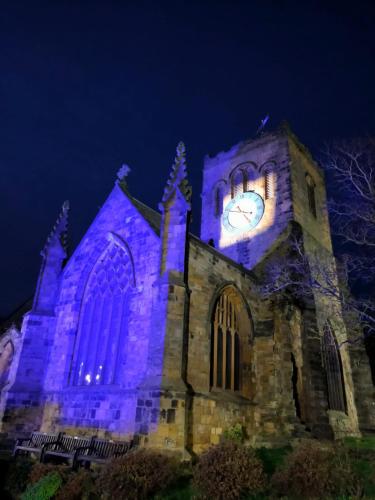 a church with a clock tower at night at St Michael's Guest House in Scarborough