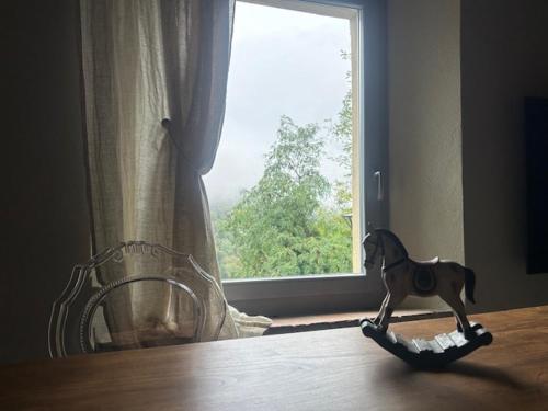 a toy horse on the floor in front of a window at Morelliana4Rooms in Scansano