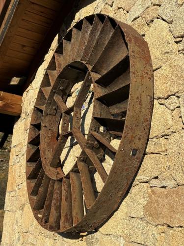 a wooden spiral staircase on the side of a building at Hotel Gredos María Justina in Navacepeda de Tormes