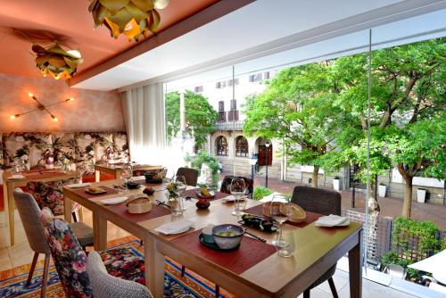 a dining room with a table and a large window at Taj Cape Town in Cape Town