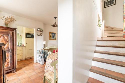 a hallway with a staircase and a room with a bed at Résidence du Capitaine Havre de paix à la mer in La Barre-de-Monts