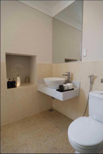 a bathroom with a white toilet and a sink at 2bi s home DALAT 2 in Da Lat