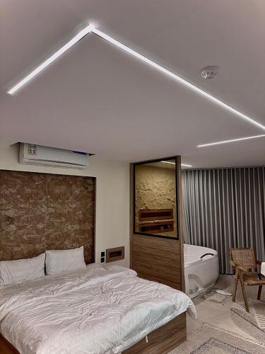 a bedroom with a large bed and a sink at شقق اجنحة تارا in Khamis Mushayt