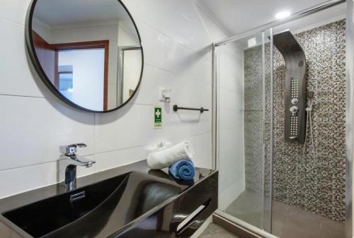 a bathroom with a sink and a mirror at Casa dos avós in São Vicente