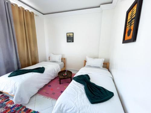 a room with two beds in a room at Locals Taghazout surfcamp in Taghazout