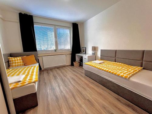 a bedroom with two beds and a window at Large 75 m2 Apartment next to Airport - Free Parking in Prievoz