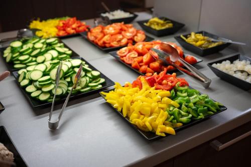 a buffet of vegetables on plates on a table at Hotel Rustikal Hustopeče - U Mandloňových sadů in Hustopeče