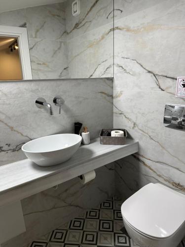 a bathroom with a sink and a toilet at Belle Athenes - Luxury Rooms at Monastiraki Railway Station in Athens