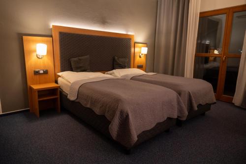 Postel nebo postele na pokoji v ubytování Hotel Rustikal Hustopeče - U Mandloňových sadů