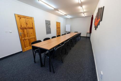 a conference room with a long table and chairs at Hotel Rustikal Hustopeče - U Mandloňových sadů in Hustopeče