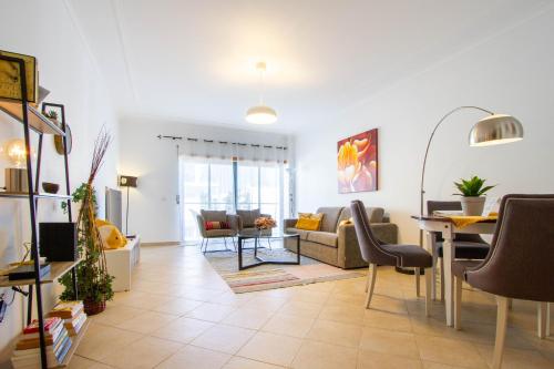 a living room with a couch and a table at Casa Happiness, swimming pool, fast WiFi, parking in Lagos