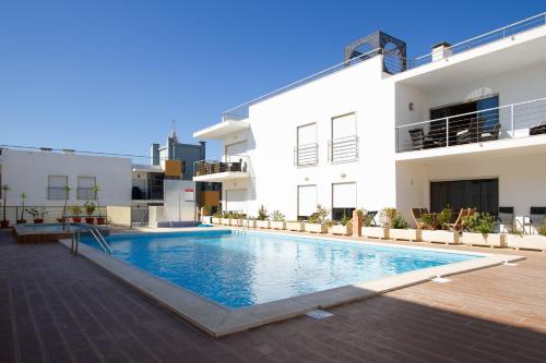 a swimming pool in front of a building at Casa Happiness, swimming pool, fast WiFi, parking in Lagos