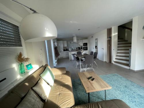 a living room with a couch and a table at Ferienhaus JONA in Burhave