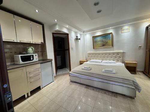 a bedroom with a bed and a microwave in it at Vita Mundo in Kotor