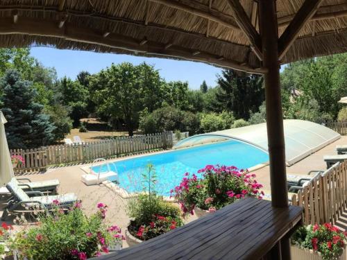 a patio with a swimming pool and flowers at Chambres d'hôtes de charme au Pays des Châteaux avec Wi-Fi - FR-1-590-333 in Tavers