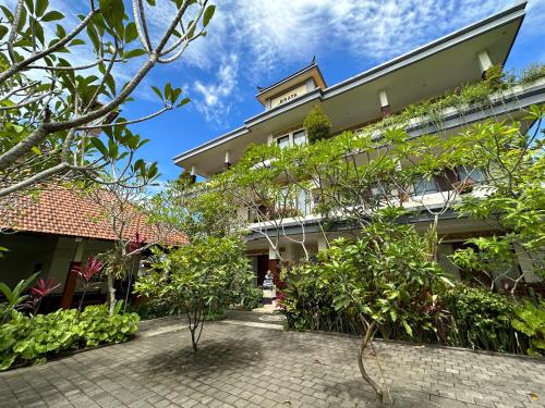 an exterior view of a building with plants at Brata Cottage Ubud in Ubud