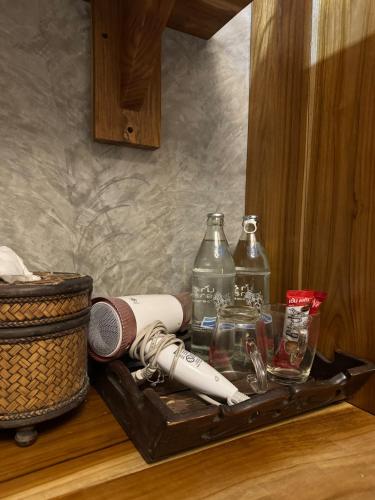 a tray with a microphone and bottles on a counter at Love Room - Center Thong Sala - Swimming Pool in Thongsala