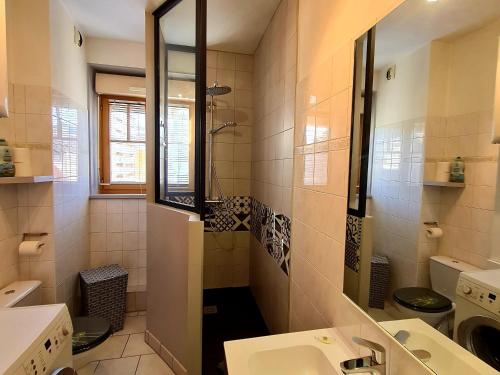a bathroom with a sink and a toilet and a mirror at Bel appart au centre avec terrasse et parking - FR-1-589-674 in Gérardmer