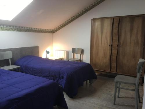 a bedroom with two beds and a wooden cabinet at Gîte en Lorraine : 3 ch, jardin, proche Lac de Madine - FR-1-584-335 in Saint-Baussant