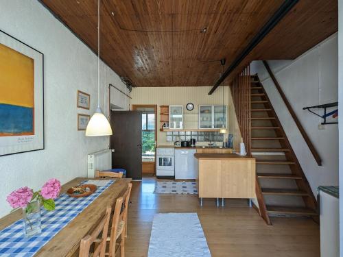 une cuisine et une salle à manger avec une table et un escalier dans l'établissement Grande maison de campagne avec jardin et cheminée près d'une plage - FR-1-591-634, à Lurais