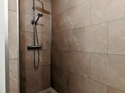 a shower with a shower head in a bathroom at Gîte rénové avec parking à proximité de Saint-Dié-des-Vosges - FR-1-589-675 in Saint-Michel-sur-Meurthe