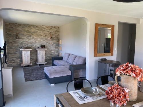 a living room with a couch and a table at Maison spacieuse avec spa, animaux acceptés, près d'Épinal - FR-1-589-680 in Dounoux