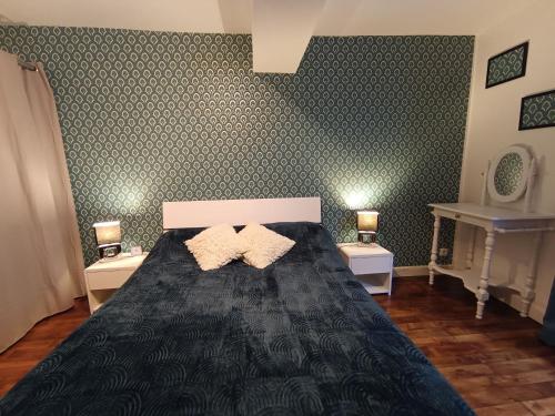 a bedroom with a black bed with two night stands at Maison médiévale en Berry avec cour privative et tout inclus - FR-1-591-643 in Saint-Benoît-du-Sault