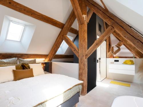 a bedroom with wooden beams and a bed in a attic at Loft moderne au charme ancien, climatisé, près de la Place Stanislas - FR-1-584-352 in Nancy