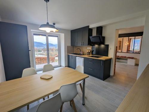 une cuisine et une salle à manger avec une table et des chaises dans l'établissement Maison rénovée près des Hautes Vosges, idéale pour activités nature - FR-1-589-696, à Saint-Nabord