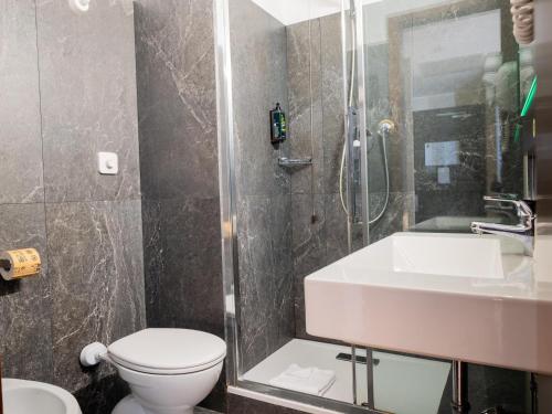 a bathroom with a sink and a toilet and a shower at B&B Hotel Trieste in Trieste