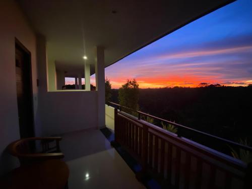 a view of a sunset from a balcony at Brata Cottage Ubud in Ubud