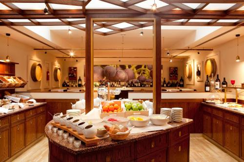 a large kitchen with a table with food on it at Vienna House by Wyndham Thüringer Hof Eisenach in Eisenach