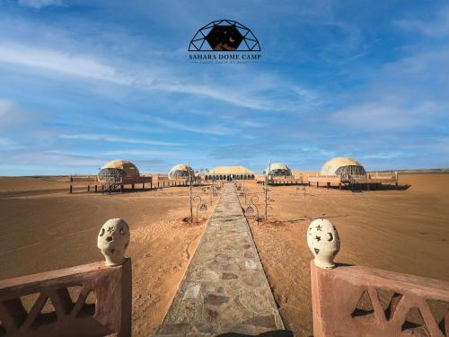 a view of a desert with domes in the background at Sahara Dome Camp in Merzouga