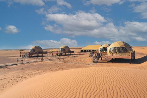 a group of tents in the middle of the desert at Sahara Dome Camp in Merzouga
