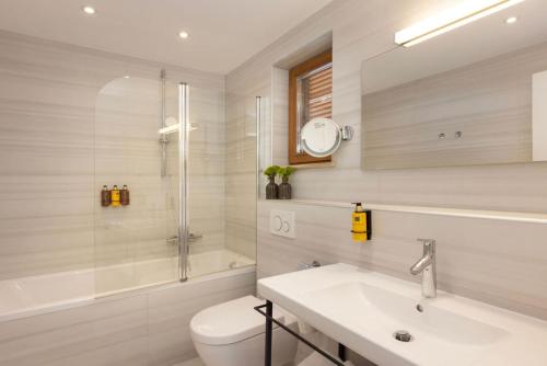 a bathroom with a sink and a toilet and a shower at Palace Natali in Dubrovnik