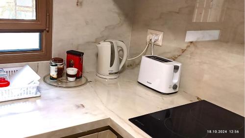 a kitchen counter with two coffee makers and a toaster at Sweet Home in Dimona