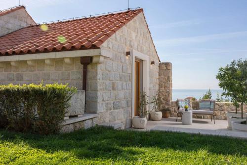a stone house with a view of the ocean at Palace Natali in Dubrovnik
