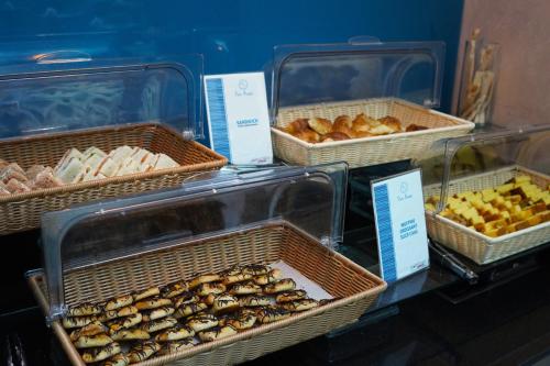 a display of trays of muffins and other pastries at FORTUNE ATRIUM HOTEL in Dubai